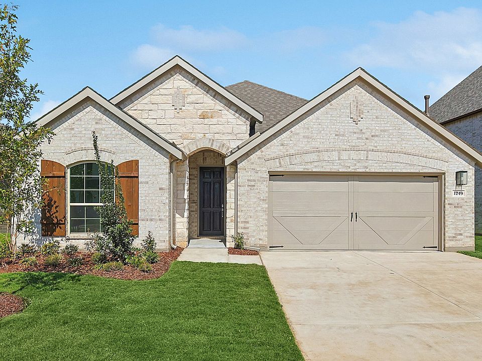 Exquisite stone facade, arched entryway, Stream Waters. Meticulous landscaping enhances curb appeal.