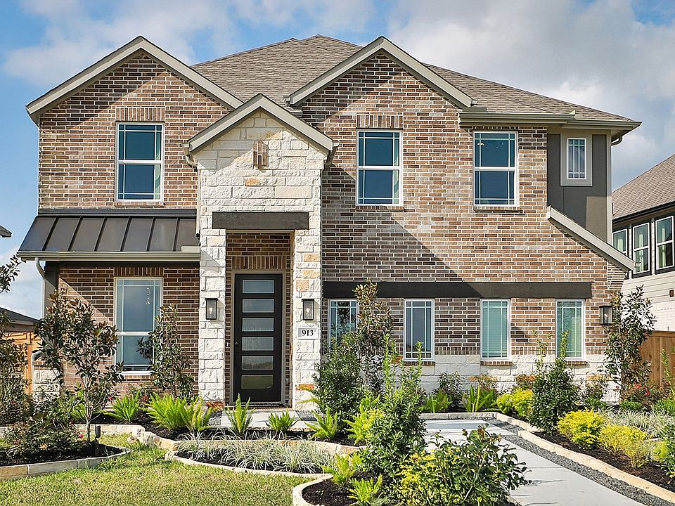 Luxurious brick facade with exquisite stone accents and lush landscaping in Clear Creek s prestigiou