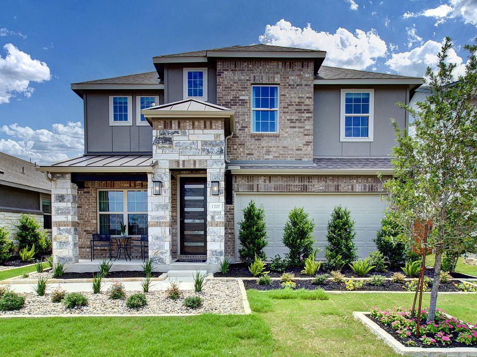 Elegant Meyer Ranch home features a stately brick facade, stone accents, and pristine landscaping fo