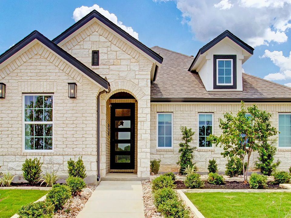 This Sunflower Ridge home boasts exquisite brickwork and lush landscaping, ideal for luxury living.
