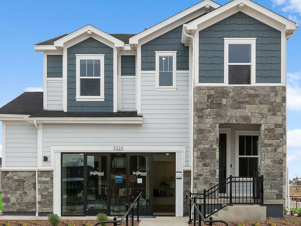 Exquisite stone facade complements elegant blue siding, creating a chic aesthetic in the Bloom commu