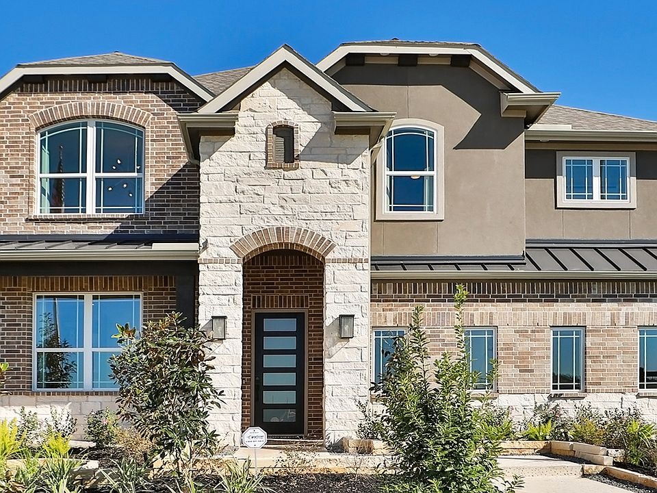Exquisite brickwork and arched windows define this modern Brookewater residence.