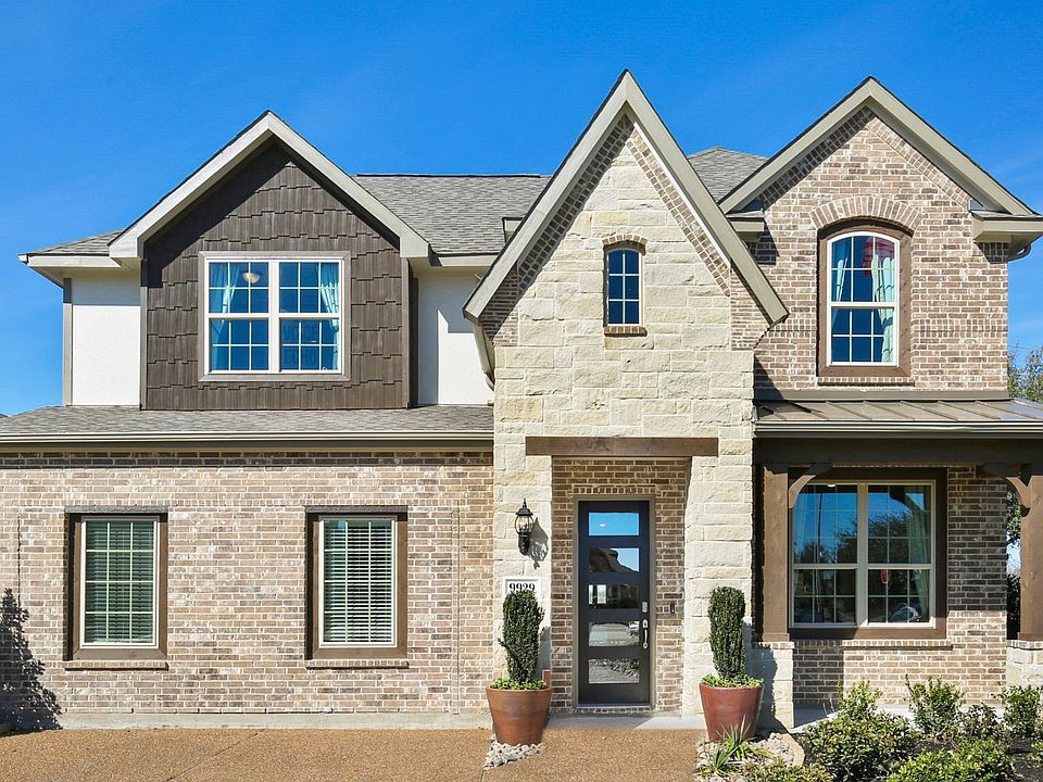 Stunning Creekhaven home with elegant brickwork, pristine stone features, and expansive windows.