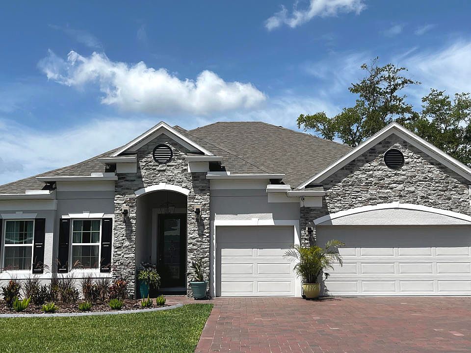 The only lakefront community with 1 2 acre homesites that includes a 3-car garage in Astatula.