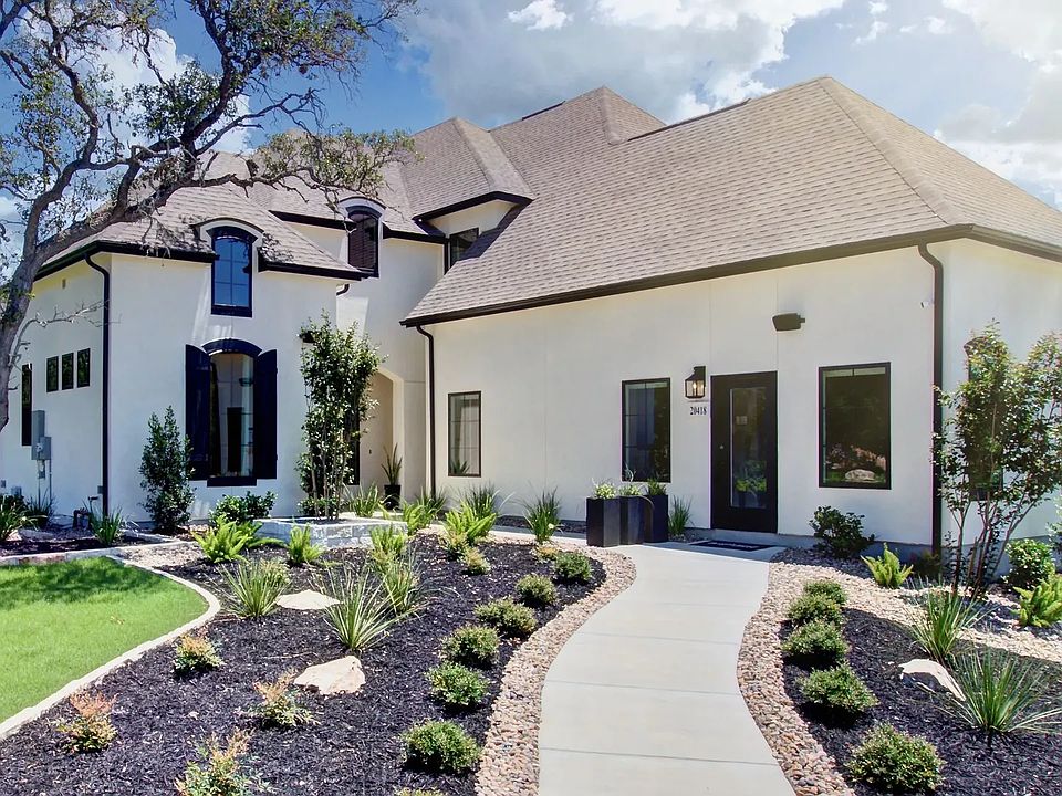 This Verandas at the Rim home features exquisite dormer windows and elegant landscaping, offering un