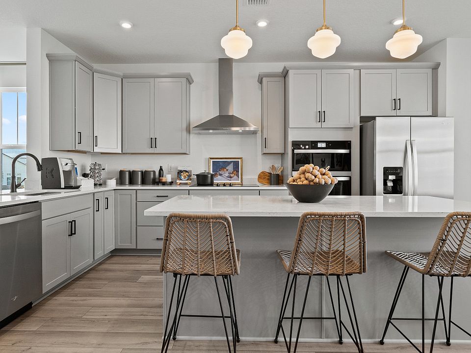 Open-concept gourmet kitchen with sleek gray cabinets and plenty of natural light--style meets funct