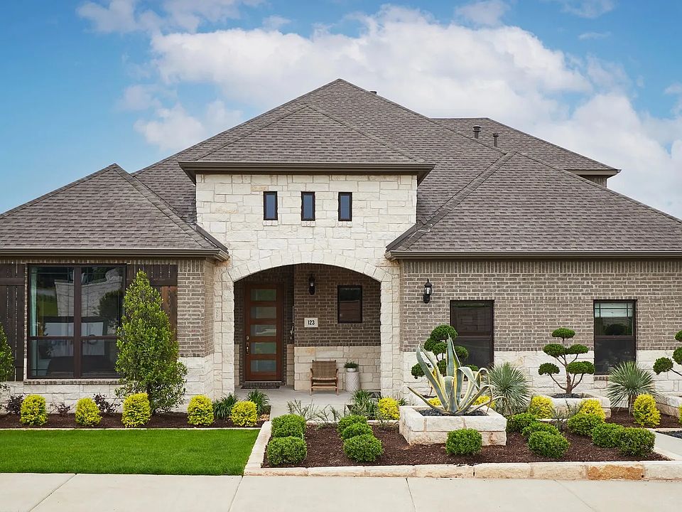 Elegant blend of stone and brick facade with lush landscaping, Anthem community.