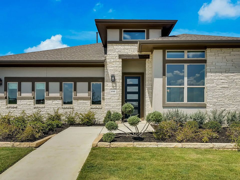 Elegant brick facade and expansive windows define this luxurious Carillon community residence.