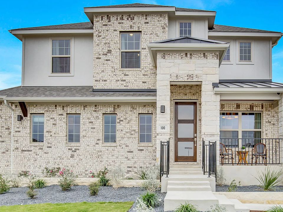 Luxurious brick facade boasts large windows and elegant porch in Opal Ranch, Texas, exuding refined