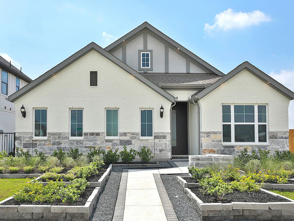 Exquisite gabled home in Bridgeland with pristine stonework and lush landscaping.