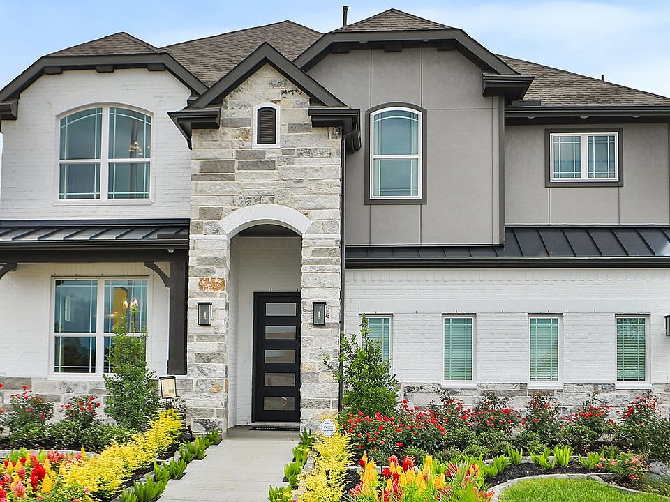 Exquisite stone and brick facade blend effortlessly in this Katy Lakes gem, surrounded by vibrant la