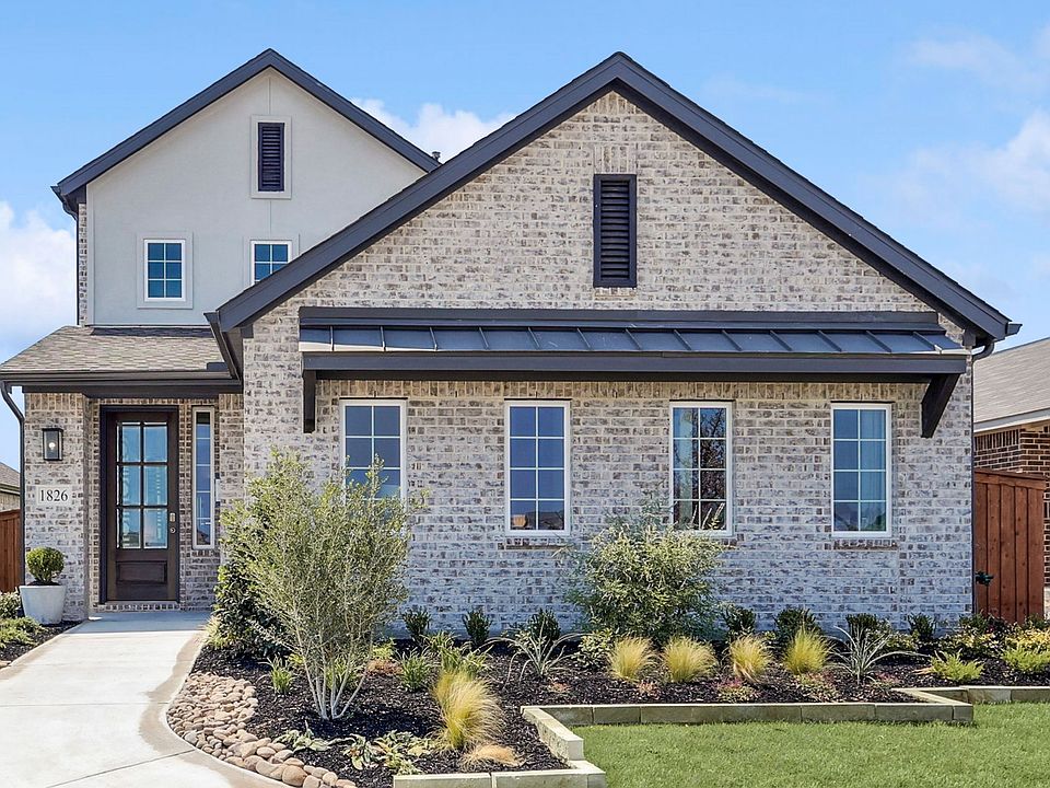 Stunning brick facade, expansive windows in Walden Pond. Elegant gabled roof complements manicured l