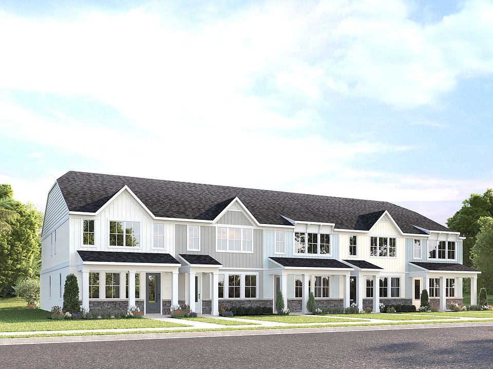 Townhomes in the Lakes District with lake views, classic exteriors, and spacious 2-car garages.
