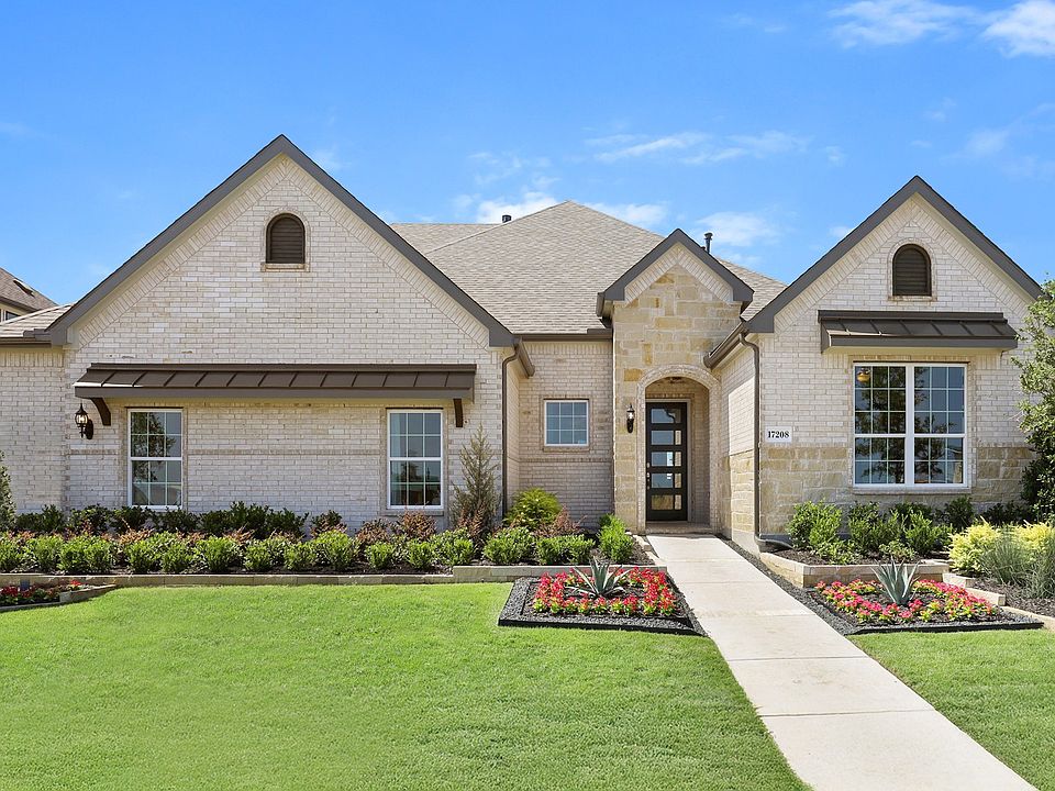 Luxurious arched windows and meticulously landscaped garden in Lakeshore Bluffs.