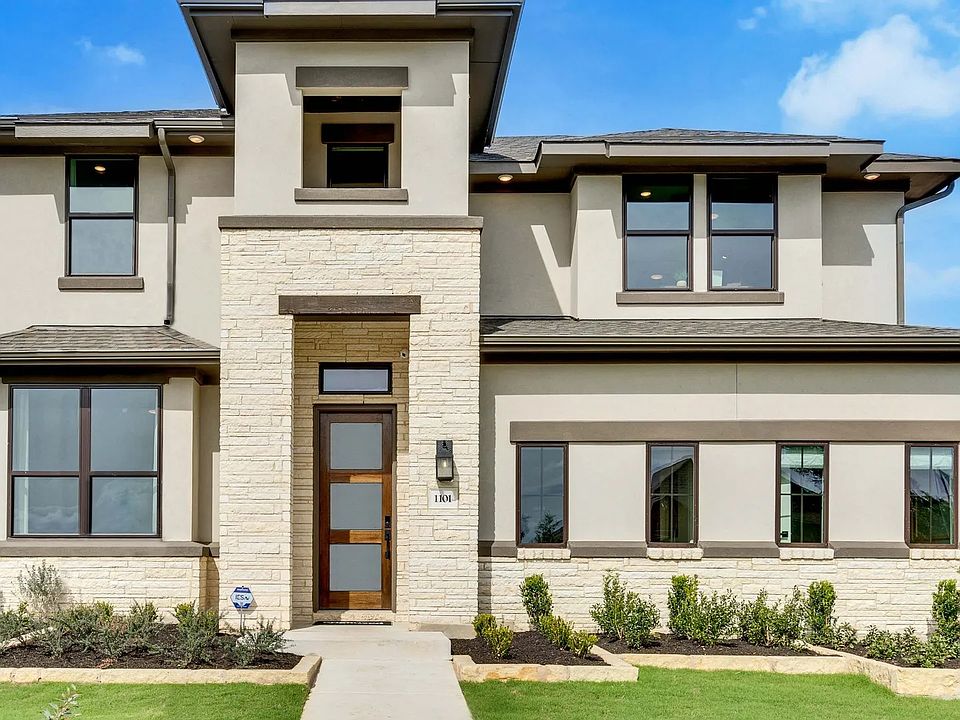 Elegant two-story home featuring stone accents and sleek stucco facade in San Gabriel, Texas.